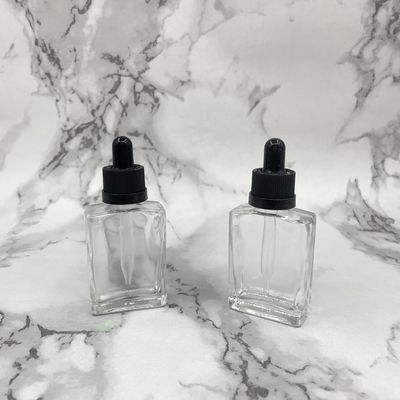 Le cosmétique en verre de la place 30ml met le chapeau en bouteille sans danger pour les enfants de compte-gouttes pour l'huile de soins capillaires