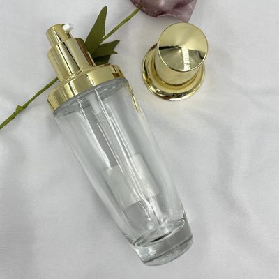 couleur adaptée aux besoins du client par lotion cosmétique ovale transparente de chapeau d'or de la bouteille 100ml